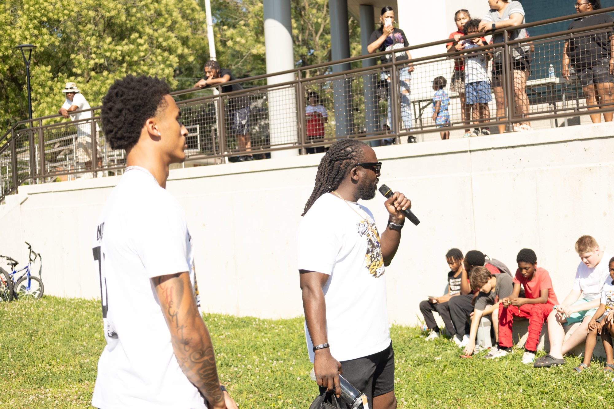 MRSS leader speaking to families and youth at an outdoor community event
